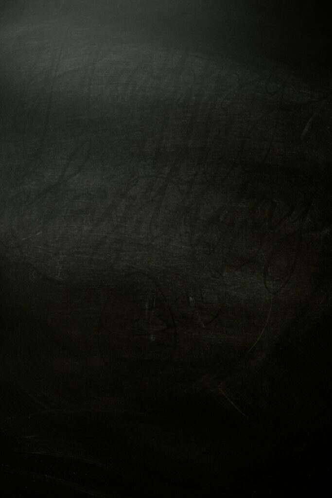 A textured dark chalkboard background, perfect for design projects.